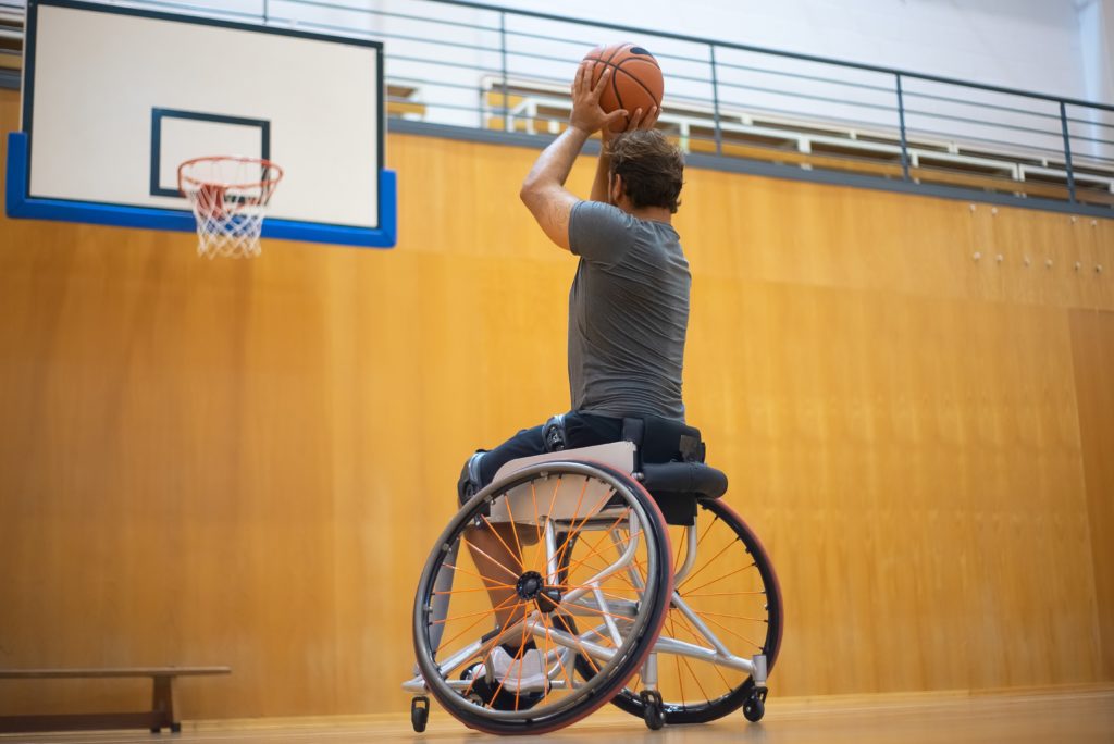 Man who uses a wheelchair playing basketball