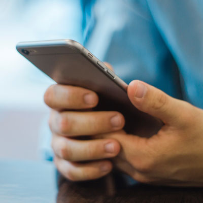 Two hands holding a cell phone