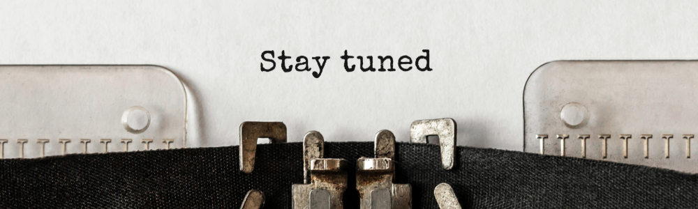 top of a typewriter with the words, "Stay tuned"